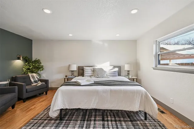a bedroom with a large bed and a chandelier