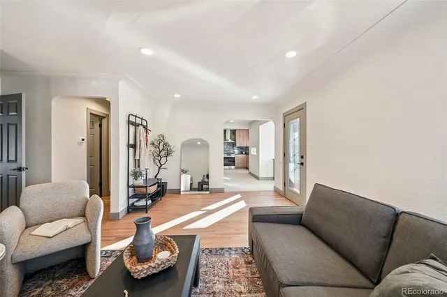 a living room with furniture and wooden floor