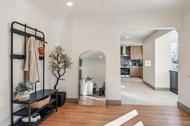 a kitchen with granite countertop a stove a sink and a refrigerator