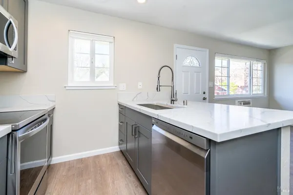 a view of a kitchen with fridge and workspace