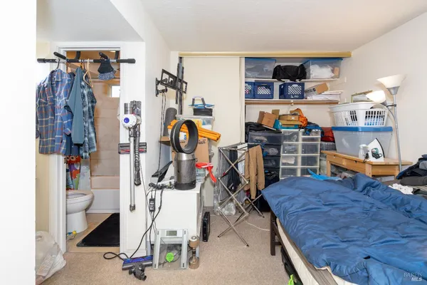 a living room with lots of furniture and a refrigerator