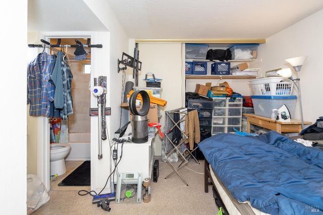 a living room with lots of furniture and a refrigerator