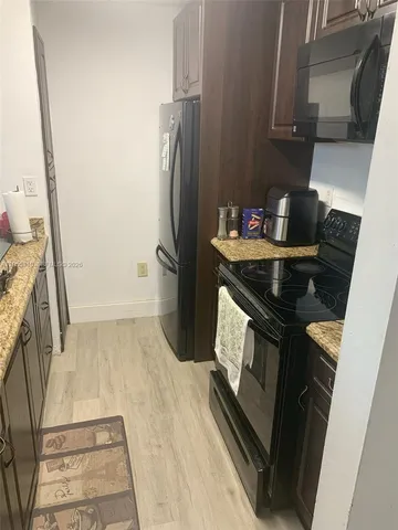 a kitchen with a stove and a refrigerator