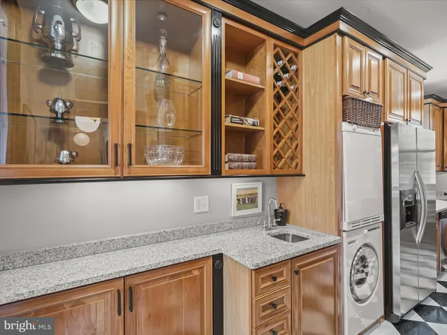 a bathroom with a granite countertop sink and a shower