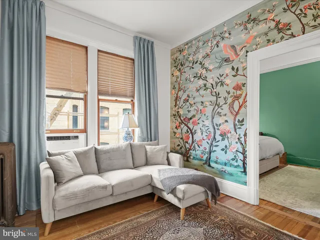 a living room with a couch and a window