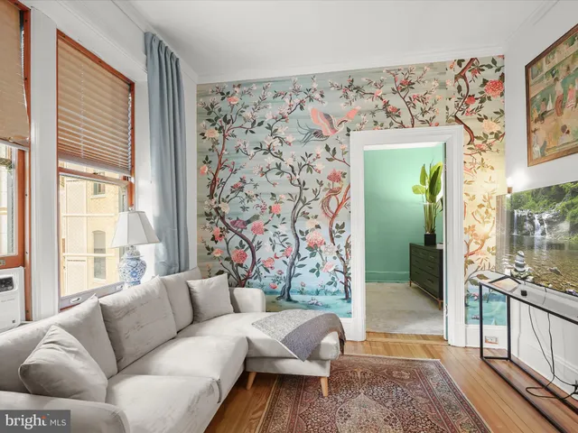 a living room with furniture and a floor to ceiling window