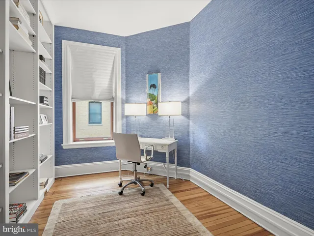 a workspace with wooden floor and a window