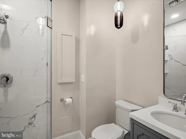 a bathroom with a toilet sink and shower