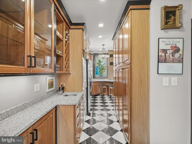 a bathroom with a granite countertop sink a mirror and shower
