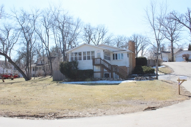 28621 Valley Road Ingleside, IL 60041 - Photo 2 of 24 a view of a house with snow on the background