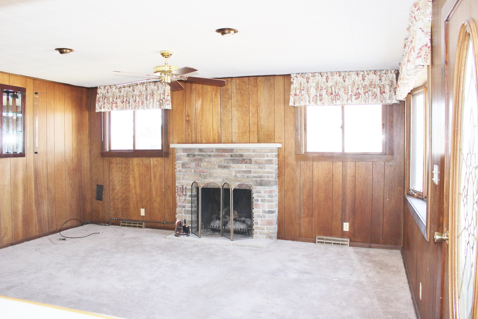 28621 Valley Road Ingleside, IL 60041 - Photo 6 of 24 a view of an empty room with a fireplace and a window