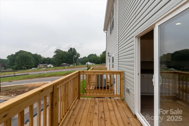 a view of balcony with wooden floor and fence