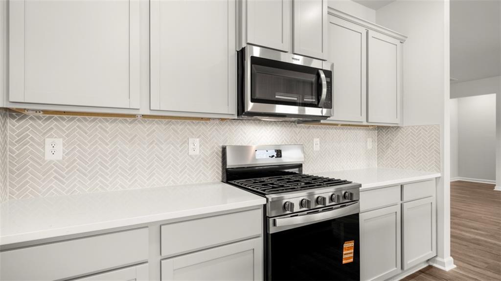 200 Defilippe Drive Statham, GA 30666 - Photo 12 of 60 a kitchen with microwave cabinets and a stove top oven
