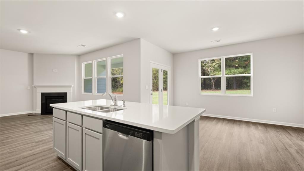 200 Defilippe Drive Statham, GA 30666 - Photo 13 of 60 a kitchen with a sink cabinets and wooden floor