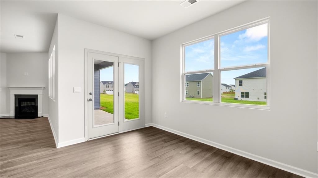 200 Defilippe Drive Statham, GA 30666 - Photo 15 of 60 an empty room with wooden floor and windows
