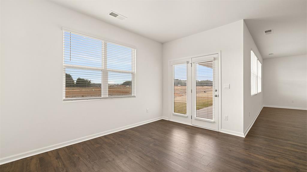 200 Defilippe Drive Statham, GA 30666 - Photo 16 of 60 an empty room with wooden floor and windows