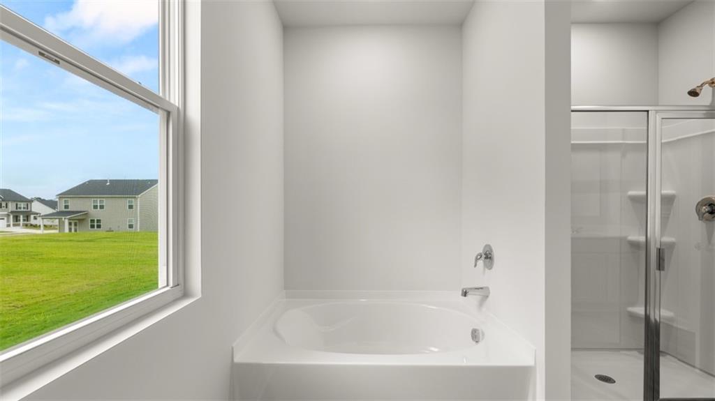 200 Defilippe Drive Statham, GA 30666 - Photo 21 of 60 a bathroom with a bathtub and shower
