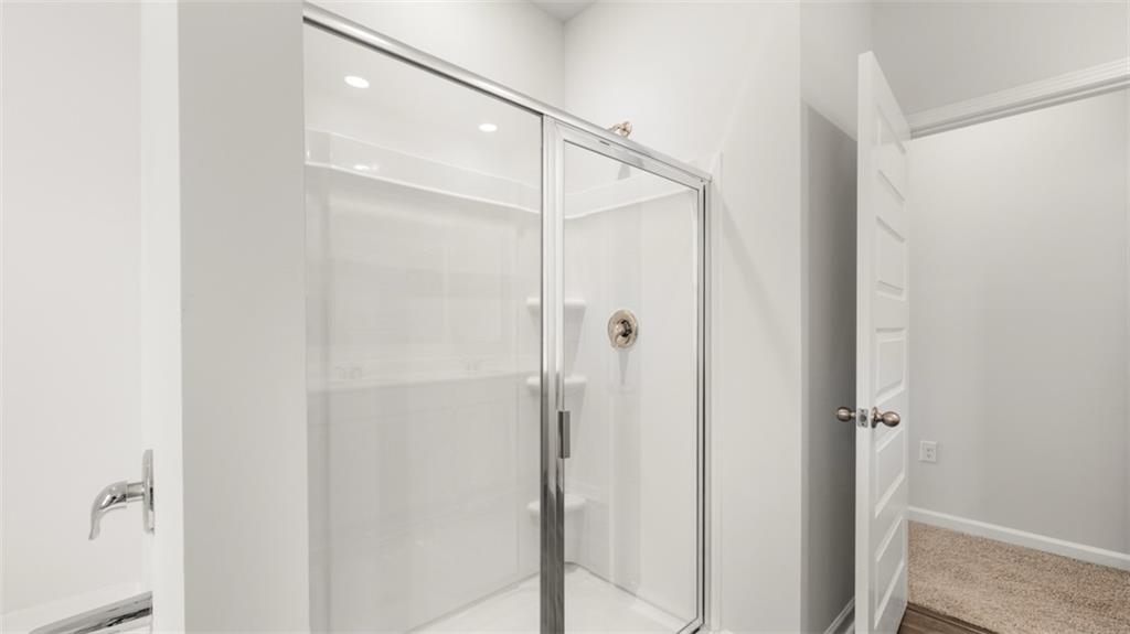 200 Defilippe Drive Statham, GA 30666 - Photo 22 of 60 a bathroom with a glass shower door