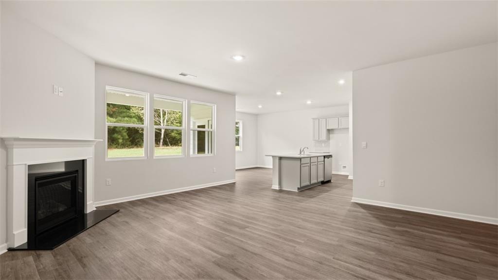 200 Defilippe Drive Statham, GA 30666 - Photo 26 of 60 a view of empty room with wooden floor and fireplace