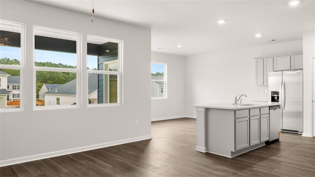 200 Defilippe Drive Statham, GA 30666 - Photo 8 of 60 a view of a big room with wooden floor and windows