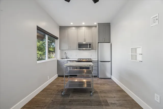 a kitchen with a refrigerator and a stove