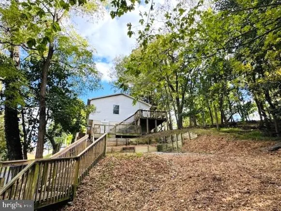 a view of a house with large trees