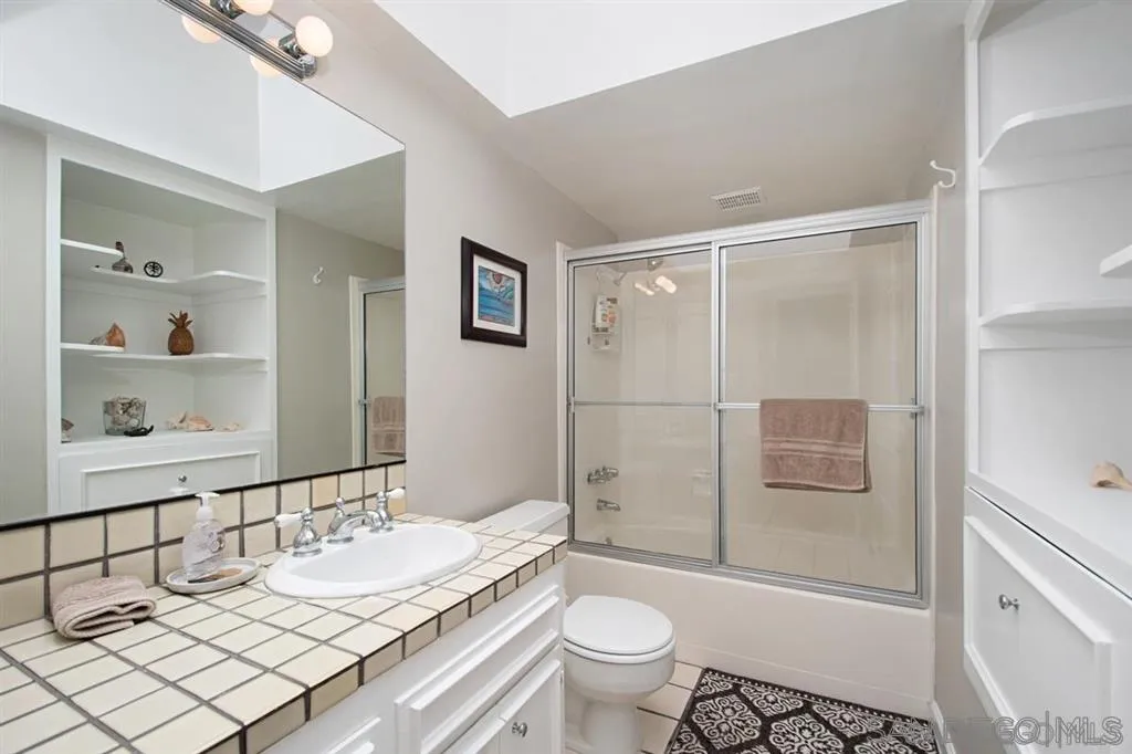 2022 Sheridan Road Encinitas, CA 92024 - Photo 14 of 25 a bathroom with a granite countertop sink toilet and shower