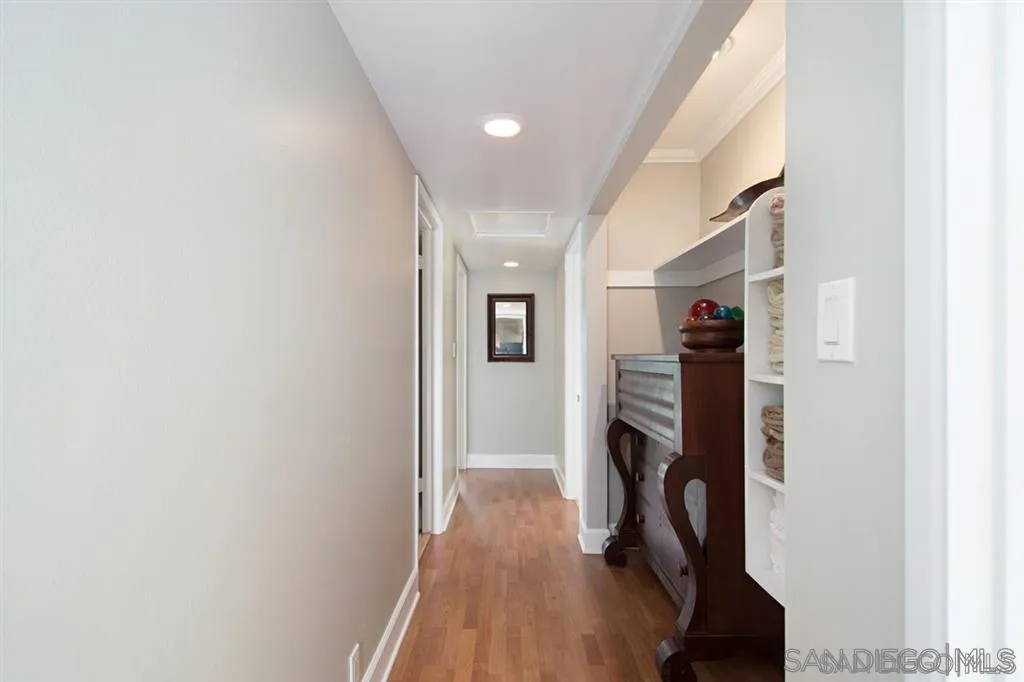 2022 Sheridan Road Encinitas, CA 92024 - Photo 15 of 25 a view of hallway with wooden floor and stairs