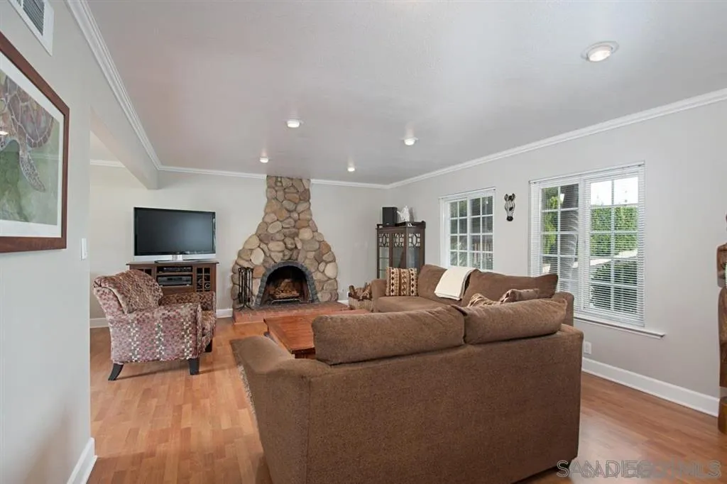2022 Sheridan Road Encinitas, CA 92024 - Photo 18 of 25 a living room with furniture a fireplace and a flat screen tv