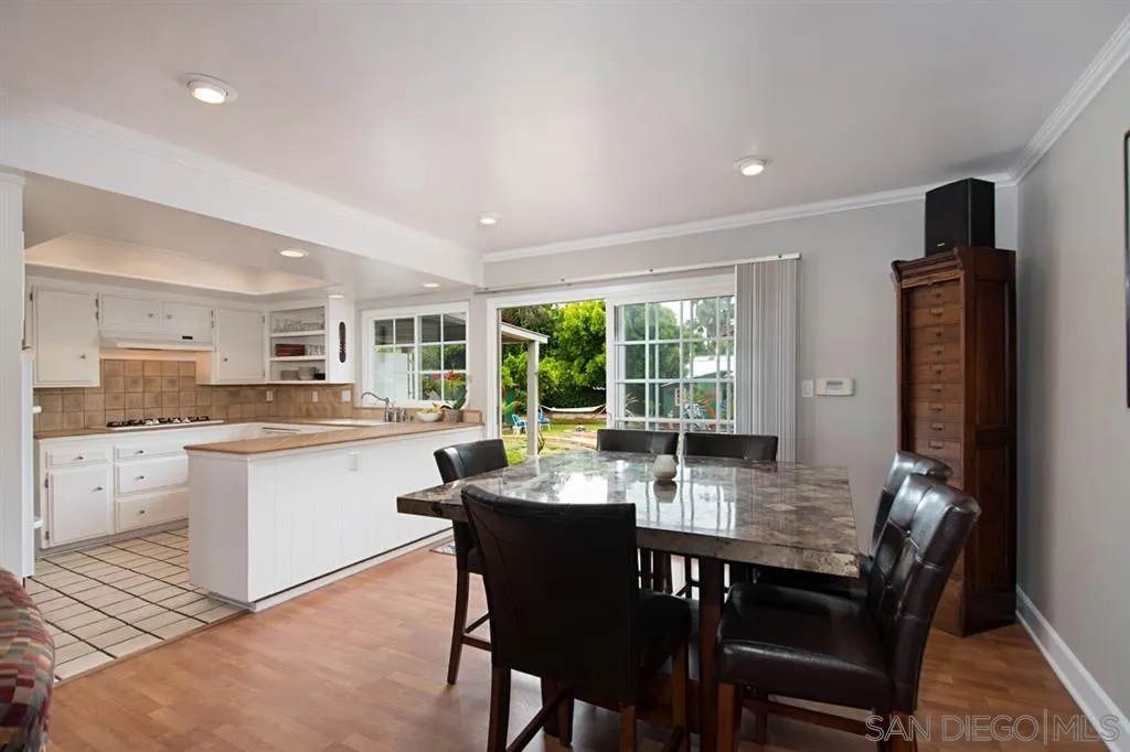 2022 Sheridan Road Encinitas, CA 92024 - Photo 5 of 25 a kitchen with a dining table chairs and refrigerator