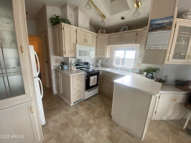 a kitchen with cabinets and stainless steel appliances