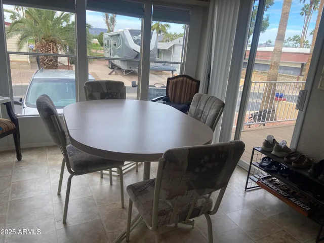 a view of a dining room with furniture wooden floor and a potted plant