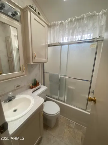 a bathroom with a sink a mirror and a shower