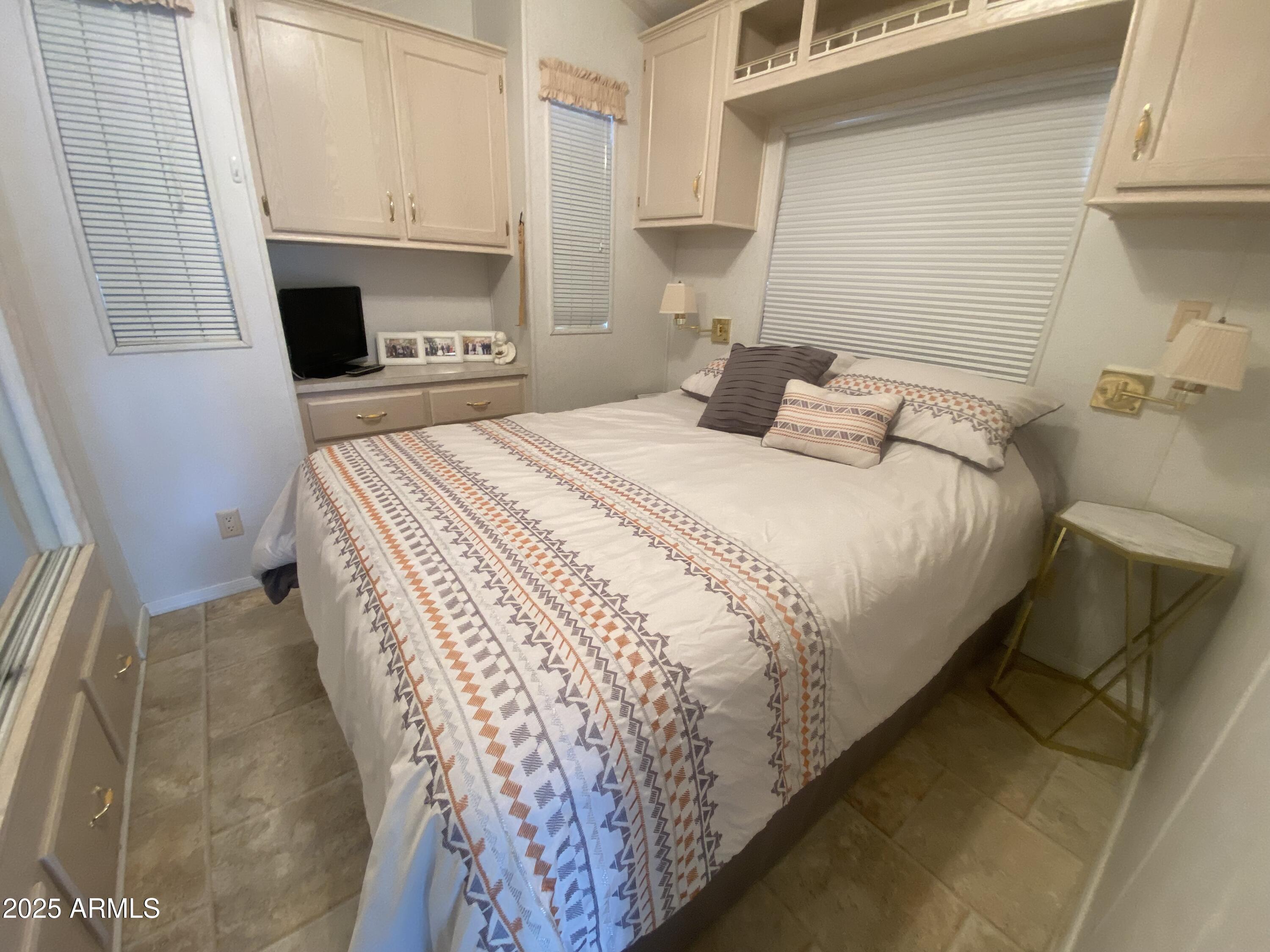 2355 South Pomo Avenue Apache Junction, AZ 85119 - Photo 19 of 32 a bedroom with a bed and a fireplace