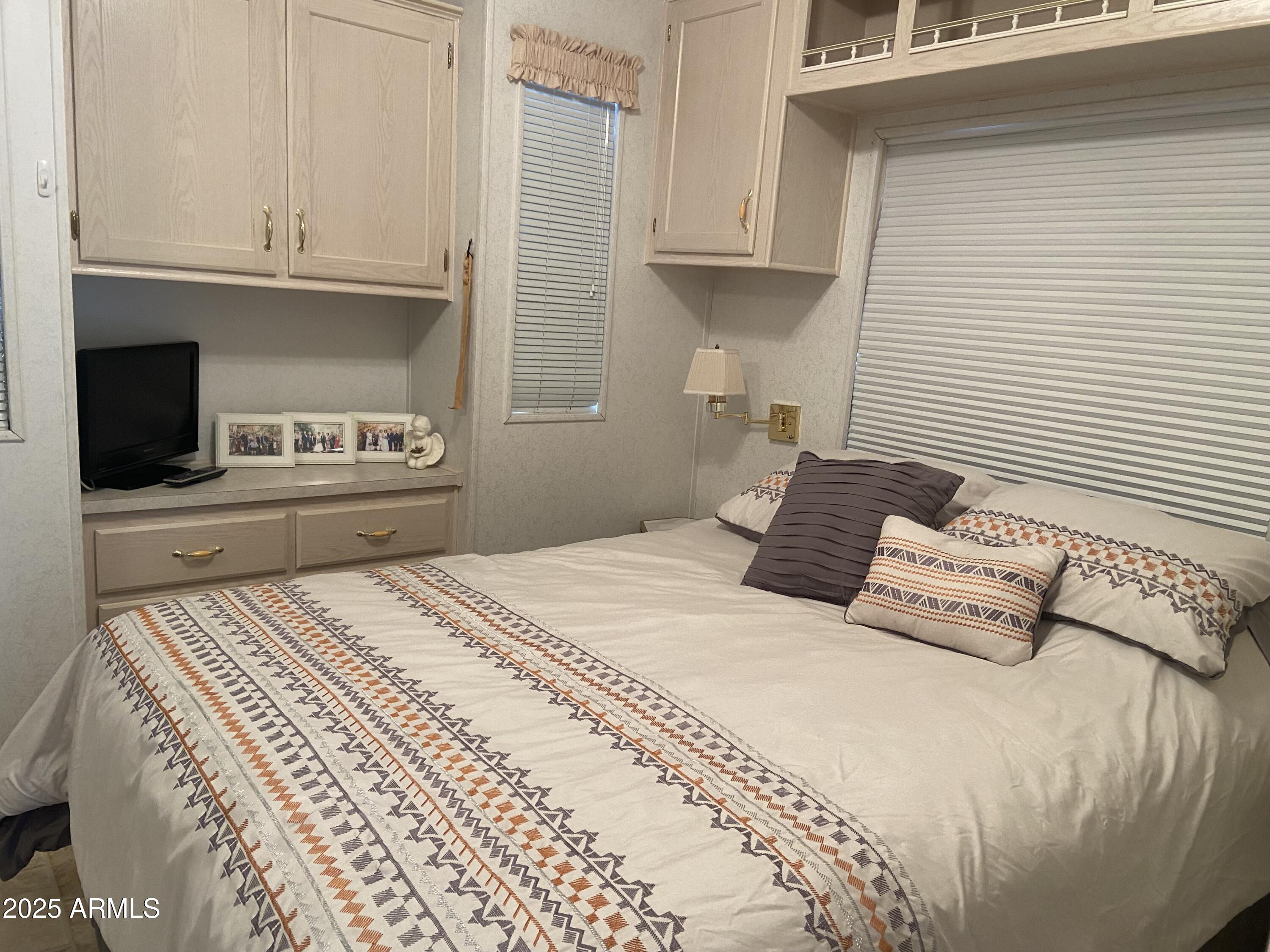 2355 South Pomo Avenue Apache Junction, AZ 85119 - Photo 20 of 32 a bedroom with a bed and a flat screen tv