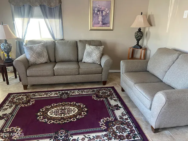 a living room with furniture and a rug