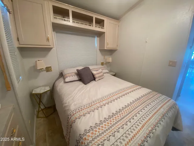 a bedroom with a bed and cabinets