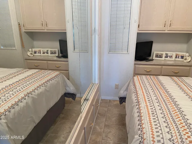 a bedroom with a bed and a television