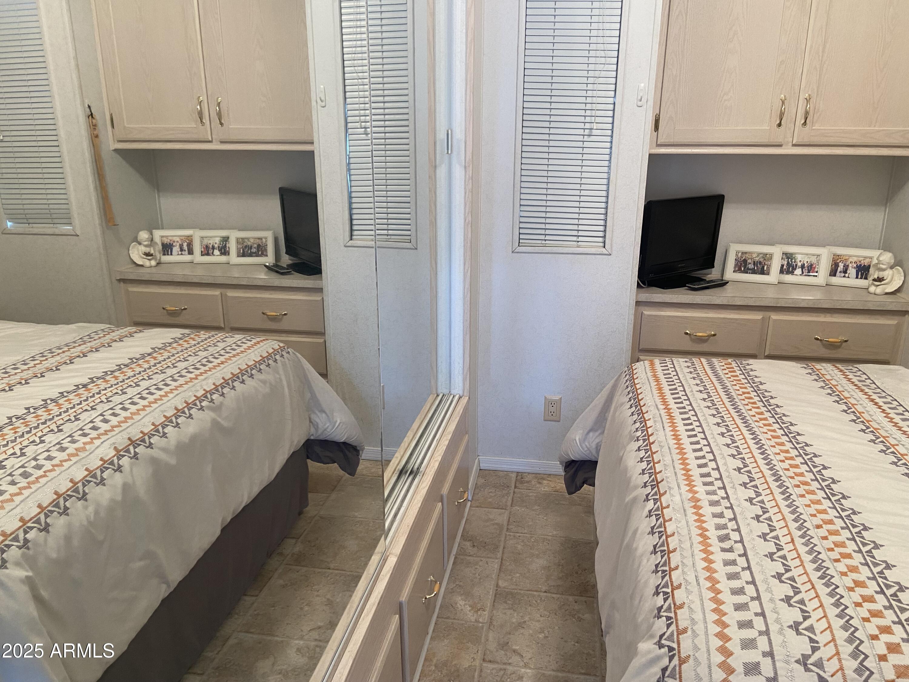 2355 South Pomo Avenue Apache Junction, AZ 85119 - Photo 22 of 32 a bedroom with a bed and a television