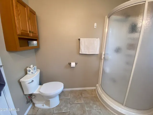 a bathroom with a toilet and a mirror