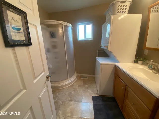 a bathroom with a sink and mirror with toilet