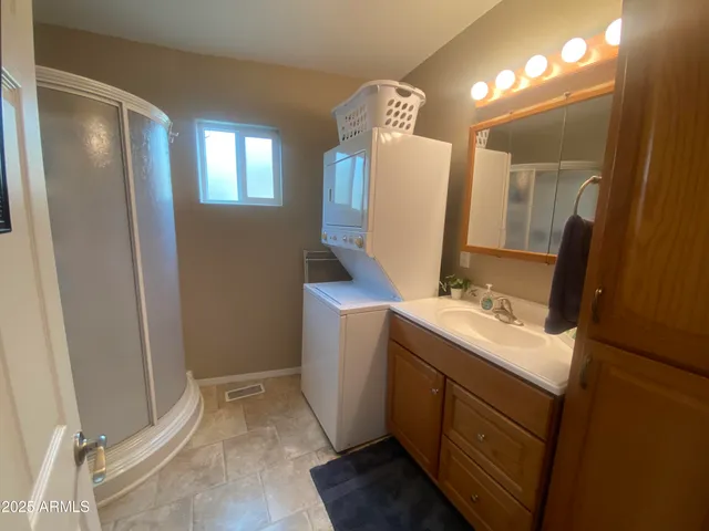 a bathroom with a sink and mirror with toilet