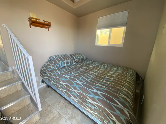 a bedroom with a bed and a window