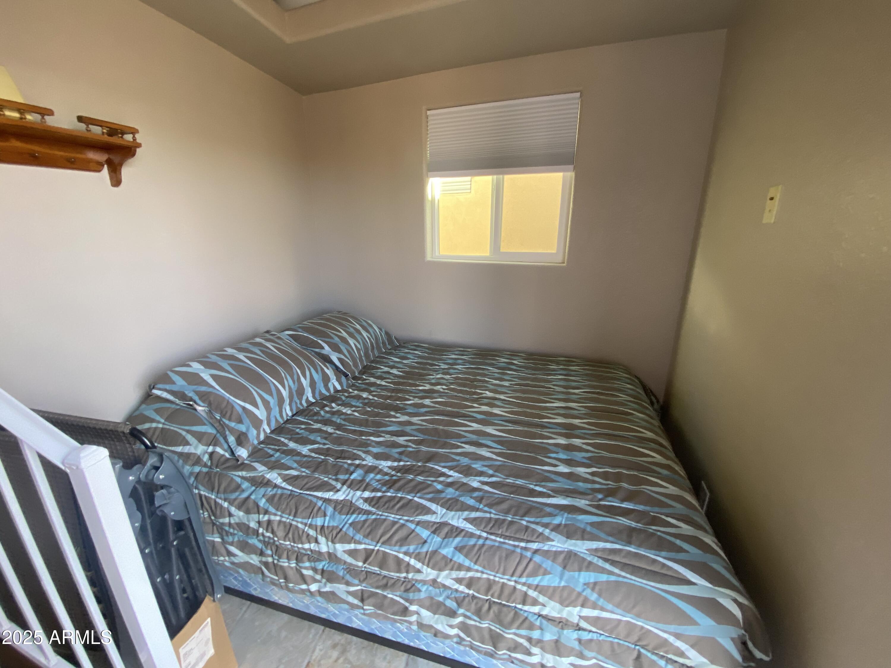 2355 South Pomo Avenue Apache Junction, AZ 85119 - Photo 28 of 32 a bedroom with a bed and a window