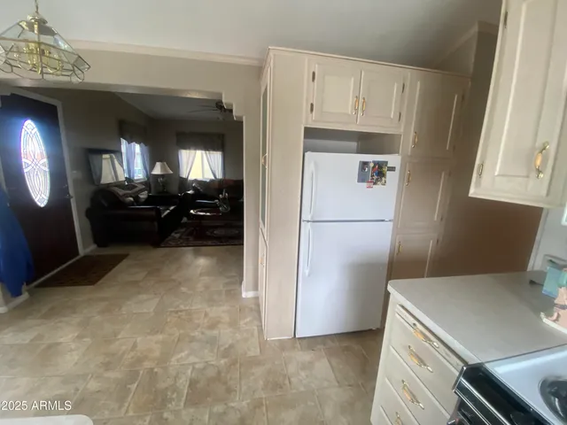 a kitchen with refrigerator cabinets and furniture