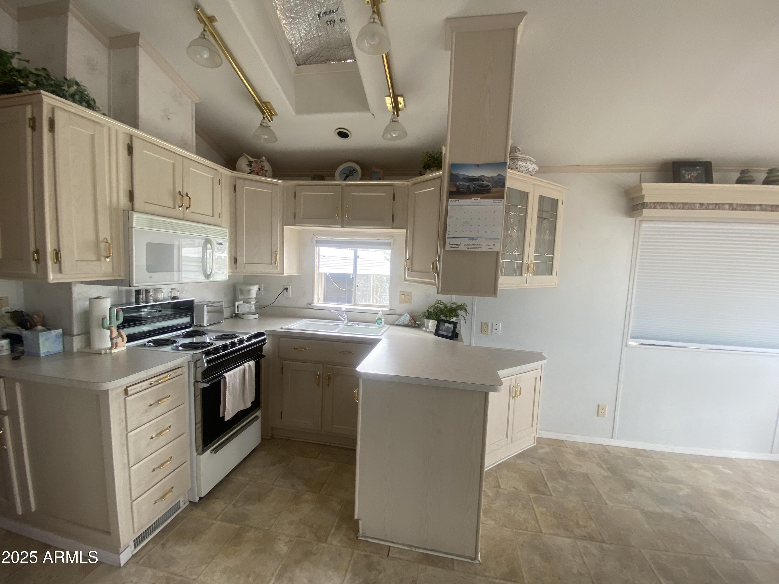 2355 South Pomo Avenue Apache Junction, AZ 85119 - Photo 7 of 32 a kitchen with stainless steel appliances granite countertop a sink stove and refrigerator