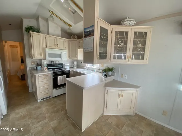a kitchen with a sink stove and refrigerator