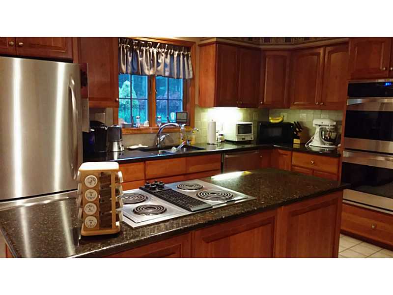 55 Falcon Ridge Drive Exeter, RI 02822 - Photo 16 of 25 Kitchen. updated kitchen has cherry cabinets, granite counters, stainless appliances