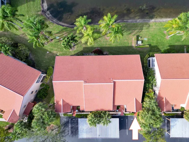 a view of a swimming pool with two chairs in a yard