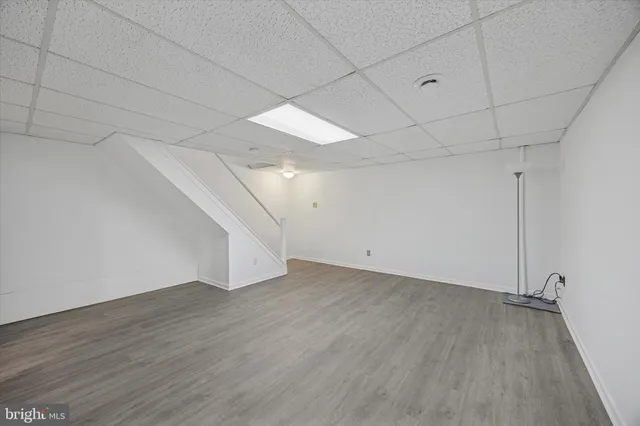 a view of a room with wooden floor and white walls